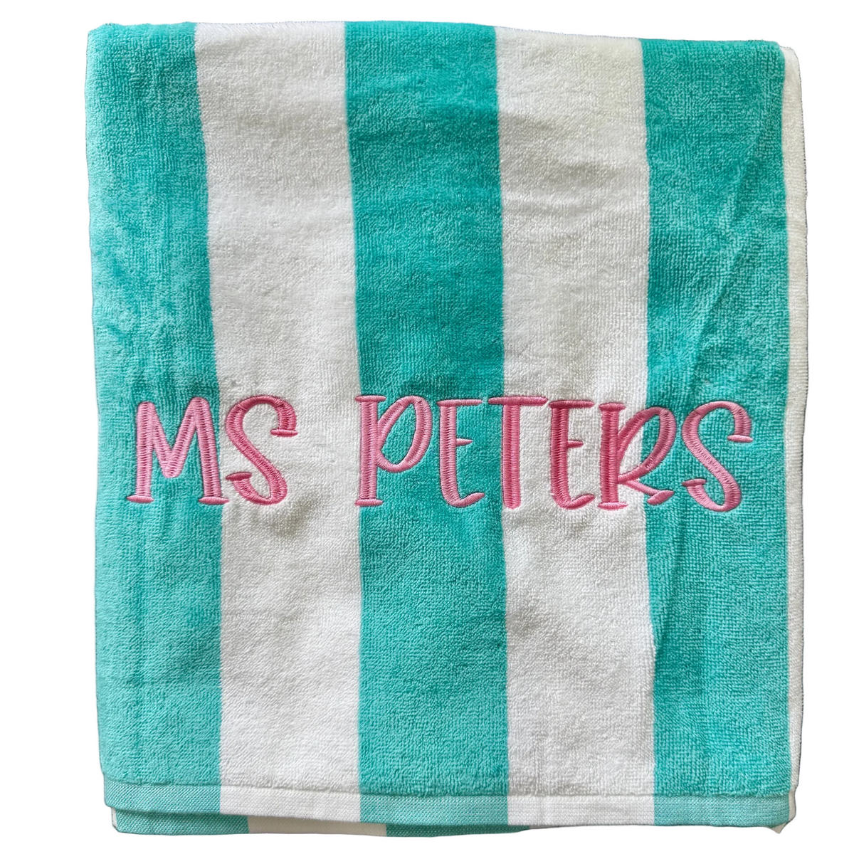 Turquoise and white striped beach towel with teacher name Ms. Peters embroidered in pink script